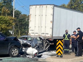 The wreckage of a car sandwiched between a transport truck and another vehicle on Huron Church Road in Windsor on Sept. 19, 2022.