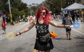 Maciejka Gorzelnik spreads bubbles over Olde Sandwich Town during Open Streets Windsor, on Sunday, Sept. 18, 2022.
