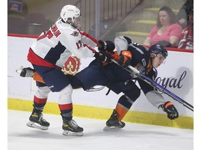 Windsor Spitfires' forward Jackson McLlwain, left, collides with Flint Firebirds' forward Alex Bradshaw during Friday's exhibition game at the WFCU Centre.