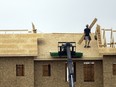A construction worker works on new homes in the east end of Regina on July 5, 2022. Construction is one of several setors facing a boom in open jobs, as Saskatchewan's economy rebounds, but lacks available entry-level and trained hires in the labour market.