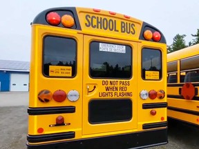The rear of a school bus in Leeds, Ontario, showing its combination of red and amber lights.