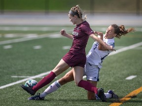 The University of Windsor Lancers' Autumn Allen breaks, right, up a scoring opportunity from McMaster's Alena Sphehar during OUA women's soccer play on Sunday at Alumni Stadium.