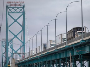 Transport trucks cross the Ambassador Bridge before passing through Canadian customs, on Friday, January 14, 2022.