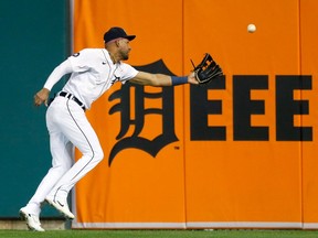 Right fielder Victor Reyes of the Detroit Tigers reaches out for a fly ball hit by Jermaine Palacios of the Minnesota Twins that bounced into the stands for a grounder-rule double during the seventh inning at Comerica Park on September 30, 2022, in Detroit, Michigan.