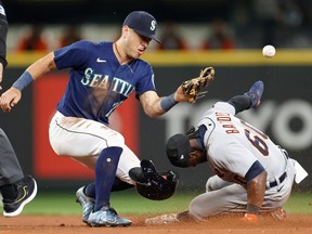 Akil Baddoo of the Detroit Tigers steals second base against Dylan Moore of the Seattle Mariners during the ninth inning at T-Mobile Park on October 03, 2022 in Seattle, Washington.