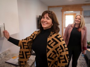 Krista Rempel, left, Executive Director at the Bridge Youth Resource Centre, is joined by Fiona Coughlin, Executive Director and CEO, Habitat for Humanity Windsor-Essex as she gets a first look at the multi-unit 3D printed home donated to the centre by the Habitat for Humanity, on Sherk Street in Leamington on Thursday, Oct. 27, 2022.