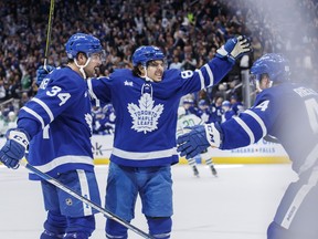 Maple Leafs' Nick Robertson (89), centre Auston Matthews (34) and defenceman Morgan Rielly celebrate Robertson's overtime goal against the Dallas Stars in Toronto on Thursday, Oct. 20, 2022.