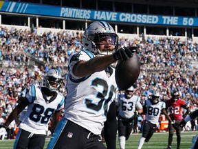 Carolina Panthers running back Chuba Hubbard (30) scores a touchdown during the second half of an NFL football game against the Tampa Bay Buccaneers Sunday, Oct. 23, 2022, in Charlotte, N.C.