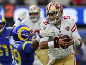 Aaron Donald of the Los Angeles Rams attempts to sack Jimmy Garoppolo of the San Francisco 49ers in the second quarter of the game at SoFi Stadium on January 09, 2022 in Inglewood, California.