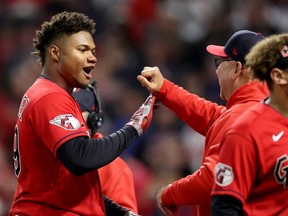 Guardians' Oscar Gonzalez, left, celebrates with manager Terry Francona, right, after a win over the Yankees in Game 3 of the American League Division Series at Progressive Field in Cleveland, Saturday, Oct. 15, 2022.