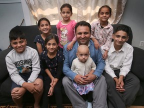 Afghan journalist Ghousuddin Frotan is shown Sept. 29, 2022, with seven of his eight children at their Windsor residence. Ghousuddin and wife Fatima and their children are among the hundreds of Afghan refugees Windsor has accepted over the past year, all fleeing their homeland after the militant Taliban took control of the country in August 2021.