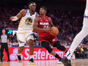 Miami Heat forward Jimmy Butler drives past Golden State Warriors forward Kevon Looney in the fourth quarter at the Chase Center.
