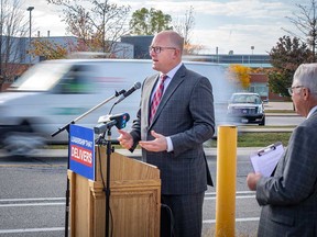Windsor Mayor Drew Dilkens speaks on traffic-calming measures as he campaigns for re-election. Ward 10 councillor Jim Morrison looks on. Photographed in Windsor on Oct. 11, 2022.