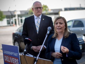 Joyce Zuk, executive director of Family Services Windsor-Essex, joins mayoral candidate, Drew Dilkens, as he holds a press conference in the parking lot behind the Paul Martin Building to discuss the issue of downtown development, on Wednesday, Oct. 5, 2022.