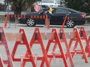 An election worker provides direction to a drive-thru voter on Saturday, Oct. 8, 2022, at Mic Mac Park in Windsor during advance polling ahead of the Oct. 24 municipal election.