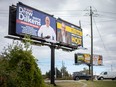 Large billboard signs of Windsor mayoral candidates, Drew Dilkens and Chris Holt, are pictured adjacent to each other at the intersection of Howard Avenue and South Cameron Boulevard, on Thursday, Sept. 29, 2022.