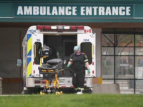 An Essex-Windsor EMS paramedic loads a stretcher onto an ambulance at the Met Campus of Windsor Regional Hospital in this April 2021 file photo.