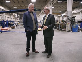 Abe Klassen, left, CEO/President of MC3 Manufacturing in Kingsville speaks with Victor Fedeli, Ontario Minister of Economic Development, Job Creation and Trade at a press conference on Wednesday, October 19, 2022.