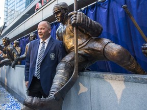 Toronto Maple Leafs alumnus Wendel Clark poses for a photo beside his bronze statue for Leafs Legends Row outside of the Air Canada Centre in Toronto, Ont. on Thursday October 5, 2017. E