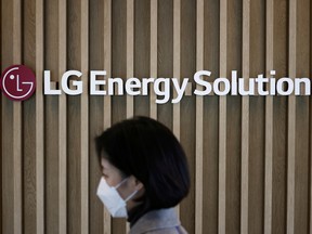 FILE PHOTO: An employee walks past the logo of LG Energy Solution at its office building in Seoul, South Korea, November 23, 2021.