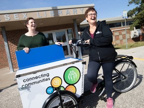 Stephanie Marshall, left, Administration Coordinator at the WindsorEssex Community Foundation, and Manuela Denes, Manager of Community Services at the Essex County Library, are pictured next to the newly unveiled MIKe the Bike, on Friday, Oct. 21, 2022.