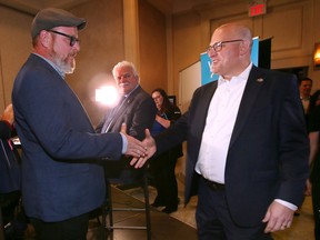 Chris Holt, left, who finished second in the Windsor mayoral race congratulates winner Drew Dilkens on Monday, October 24, 2022 at the Fogolar Furlan Club.