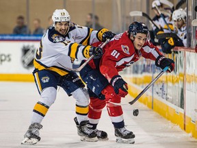 Windsor Spitfires' forward Matthew Maggio, at right, tries to control the puck along the boards while being checked by the Erie Otters' 
Elias Cohen at Erie Insurance Arena. Photo credit: Jeep DiCioccio/Erie Otters