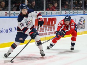 Windsor Spitfires, forward Matthew Maggio (81 at right) closes in on Saginaw's Dean Loukus (12) during Saturday's game at the Down Event Center in Saginaw, Mich. (Contributed photo)