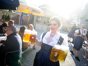 Lauren Murray serves up steins full of beer at the Heimat Banquet Centre where Oktoberfest festivities are taking place, on Saturday, Oct. 1, 2022.