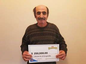 Olindo Mastronardi of Kingsville holds his $250,000 prize cheque that he won playing Instant Crossword.