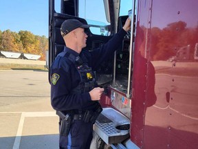An OPP officer in the process of conducting a commercial vehicle enforcement blitz in Essex County on Oct. 14, 2022.