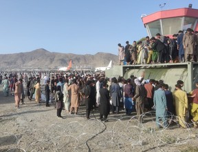 Afghan journalist Ghousuddin Frotan captured this image of a crowded scene at Kabul International Airport on Aug. 16, 2021, shortly after Taliban militants entered Afghanistan’s capital. Thousands of Afghans flocked to the airport, frantic to get out of the country. (Photo courtesy of Ghousuddin Frotan)