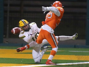 St. Clair Saints' receiver Dante Lewis, left, can't get a handle on the ball in the end zone while tangling with the Okanagan Suns' Alandro Van Holten during Saturday's game at Acumen Stadium.