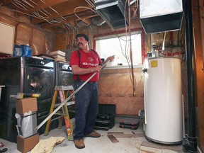 Denis Pelletier prepares to install a new furnace at the Varacalli residence in LaSalle home on Saturday, October 15, 2022. The family received a free furnace and air conditioner thanks to the Lennox and Fahrhall Home Comfort "Bring the Love" promotion.