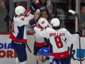 Windsor Spitfires' centre Oliver Peer, centre, and teammates celebrate one of the team's league-leading 66 goals this season despite the absence of Wyatt Johnston.