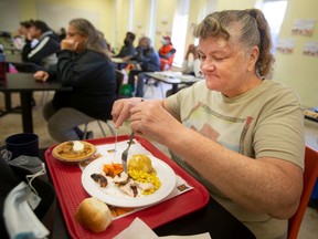 Linda Fengler enjoys a Thanksgiving turkey dinner with all the fixings at Windsor's Downtown Mission on Tuesday, Oct. 11, 2022.