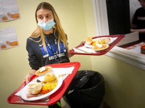 Kathryn Wakeling serves Thanksgiving turkey dinners to clients at the Downtown Mission on Tuesday.