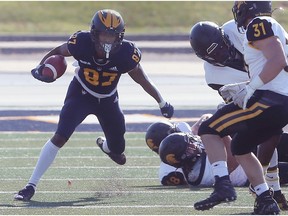 WindsorLancers' receiver Evan Martin looks for room during Saturday's 39-11 win over the Waterloo Warriors that clinched the team's first playoff spot since 2014.