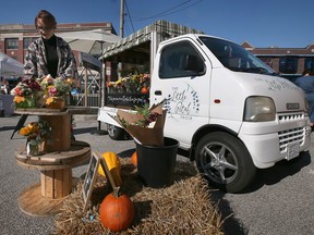Becky Young with the Little Petal Truck arranges flowers at the Walkerville Pop-Up Market on Saturday, October 22, 2022.