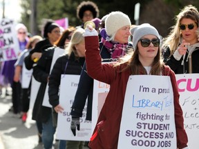 CUPE strikers (including educational assistants, library techs and other non-teaching staff) protest in front of Nepean MPP Lisa MacLeod's office on Greenbank Road in Ottawa Monday.