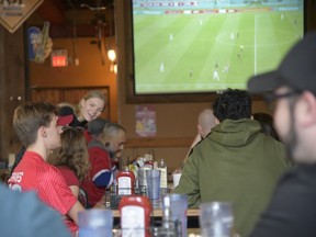 A staff member waits on tables at Rock Bottom Bar and Grill in Sandwich, which was open for Canadian soccer fans to view the Canada vs Croatia World Cup game on Sunday, Nov. 27, 2022.