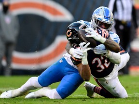 David Montgomery of the Chicago Bears catches a pass in the fourth quarter against Chris Board #49 of the Detroit Lions at Soldier Field on November 13, 2022 in Chicago, Illinois.