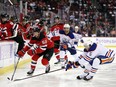 Erik Haula of the New Jersey Devils and Cody Ceci of the Edmonton Oilers compete for the puck during the 2nd period of the game at Prudential Center on November 21, 2022 in Newark, New Jersey.