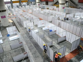 Employees work at a makeshift hospital that will be used for Covid-19 patients in Guangzhou, in China's eastern Guangdong province on April 11, 2022.