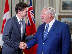 Prime Minister Justin Trudeau shakes hands with Ontario Premier Doug Ford at Queen's Park in Toronto, Aug. 30, 2022.