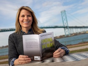 Kimberley Kirt is pictured with an anthology called Finding the Way where her story, titled From Where I Once Stood is included, while at the riverfront on Sunday, Nov. 6, 2022.