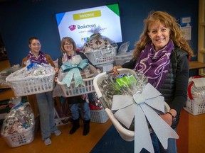 Mary-Ann Stark, Windsor Basketeers lead, is joined by Erika Broadbent, shelter supervisor at Hiatus House, and Slyvie Guenther, Hiatus House Executive Director, while at the Children's Safety Village where they were receiving baskets for those in need, on Saturday, Nov. 19, 2022.