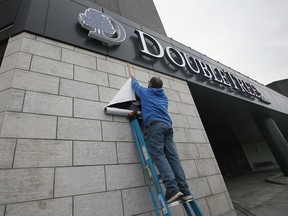 A grand opening was held for the new DoubleTree by Hilton Windsor Hotel & Suites on Tuesday, November 29, 2022. Steve Wheldon hangs up a banner before the event.