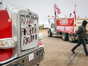 Anti-mandate demonstrators gather as a truck convoy blocks the highway the busy U.S. border crossing in Coutts, Alta., Jan. 31, 2022.