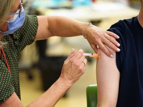 A flu shot is given in Calgary, Alberta, on October 17, 2022.